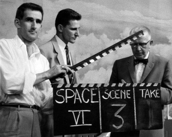 A black-and-white photograph of a 1950s film clapperboard.