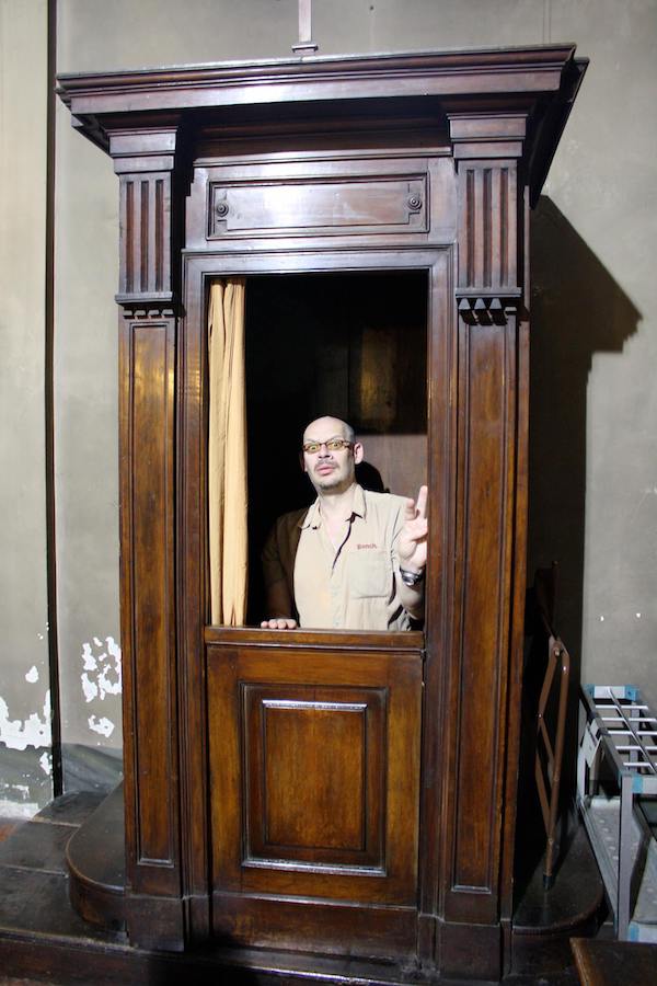Greg, looking worried because he’s in a confessional booth.